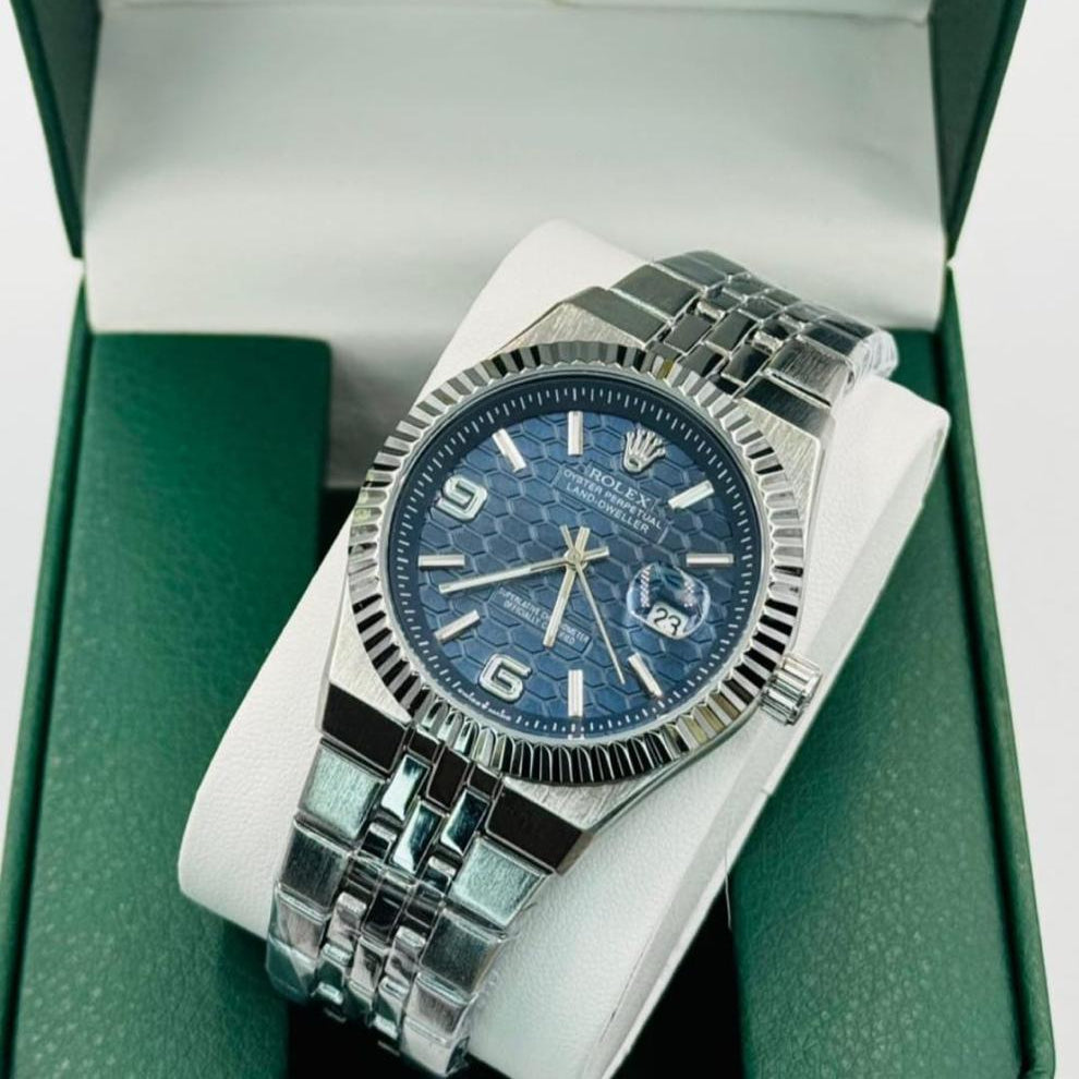Silver watch with blue face in a Rolex box
