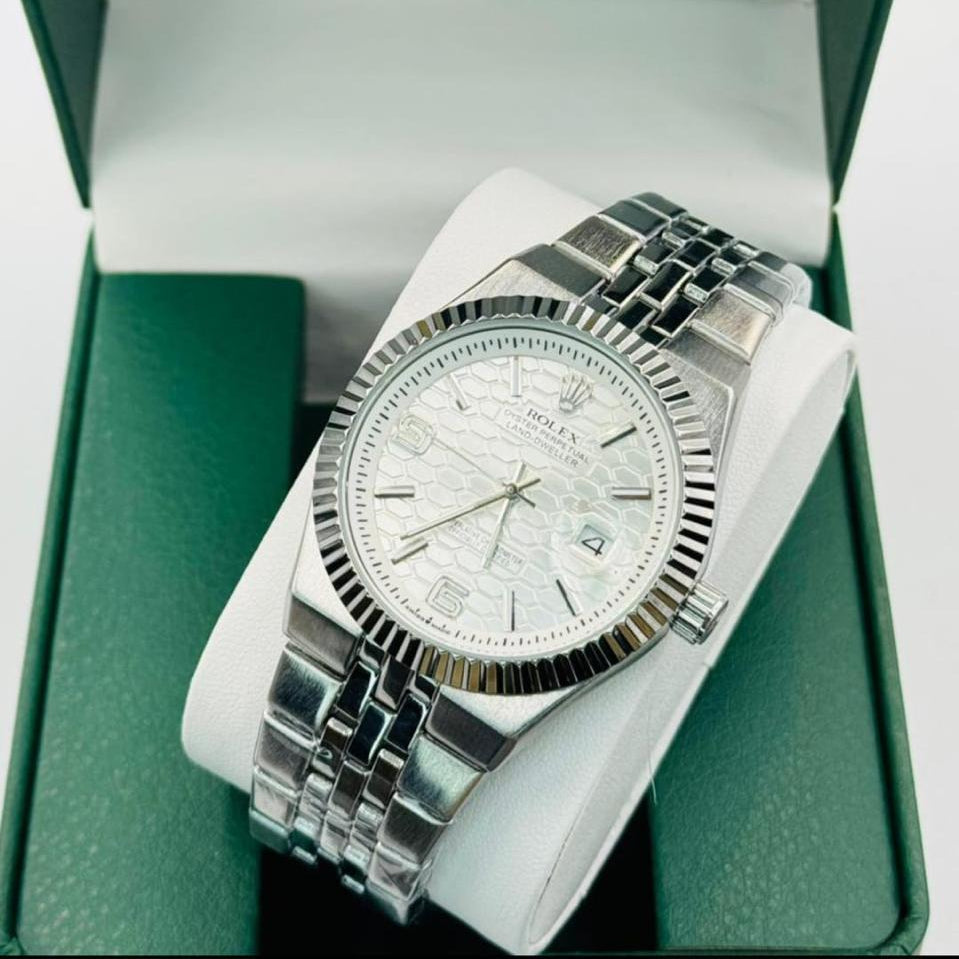 Silver Rolex watch in a green and white box